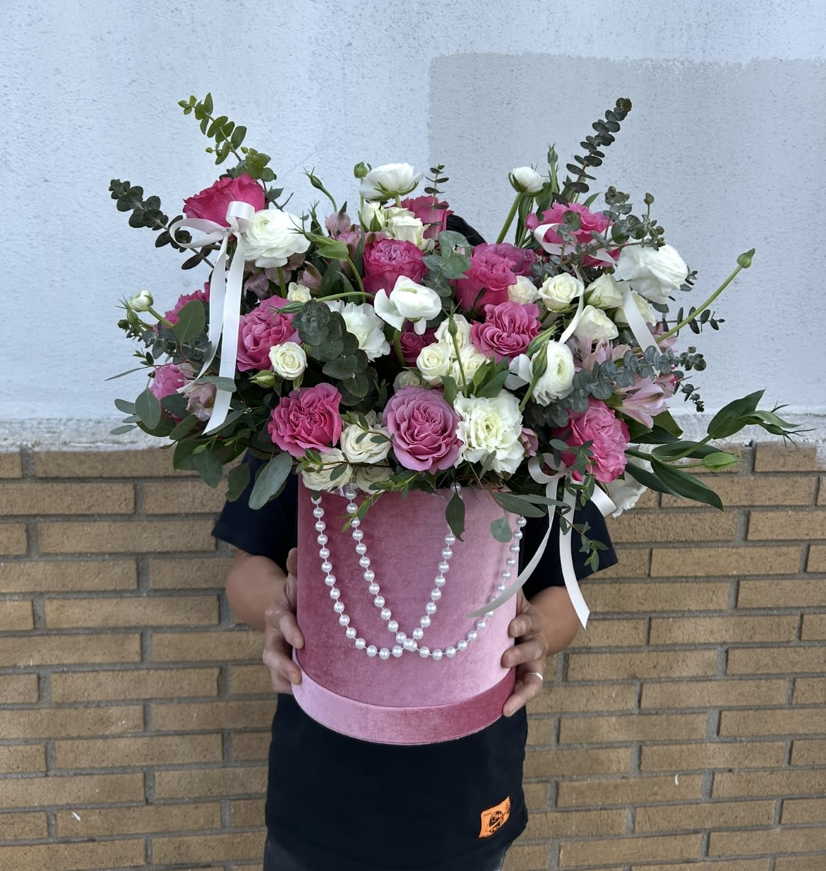 The Secret Garden - Pink roses, with a hint of lisianthus in a plush pink box with eucalyptus, airy greenery, white ribbon and draped pearls perfect for this Mother's Day