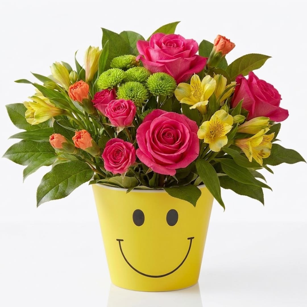 Bouquet of pink roses and yellow flowers in a yellow smiley-face pot