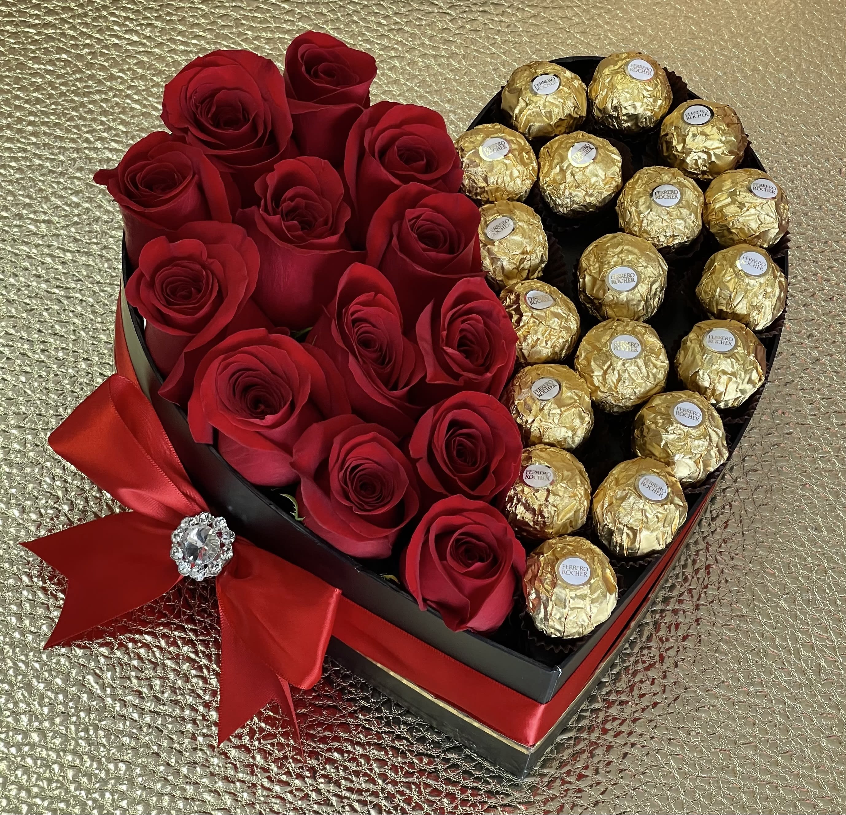 Heart-shaped box with red roses on one side and gold-wrapped chocolates on the other