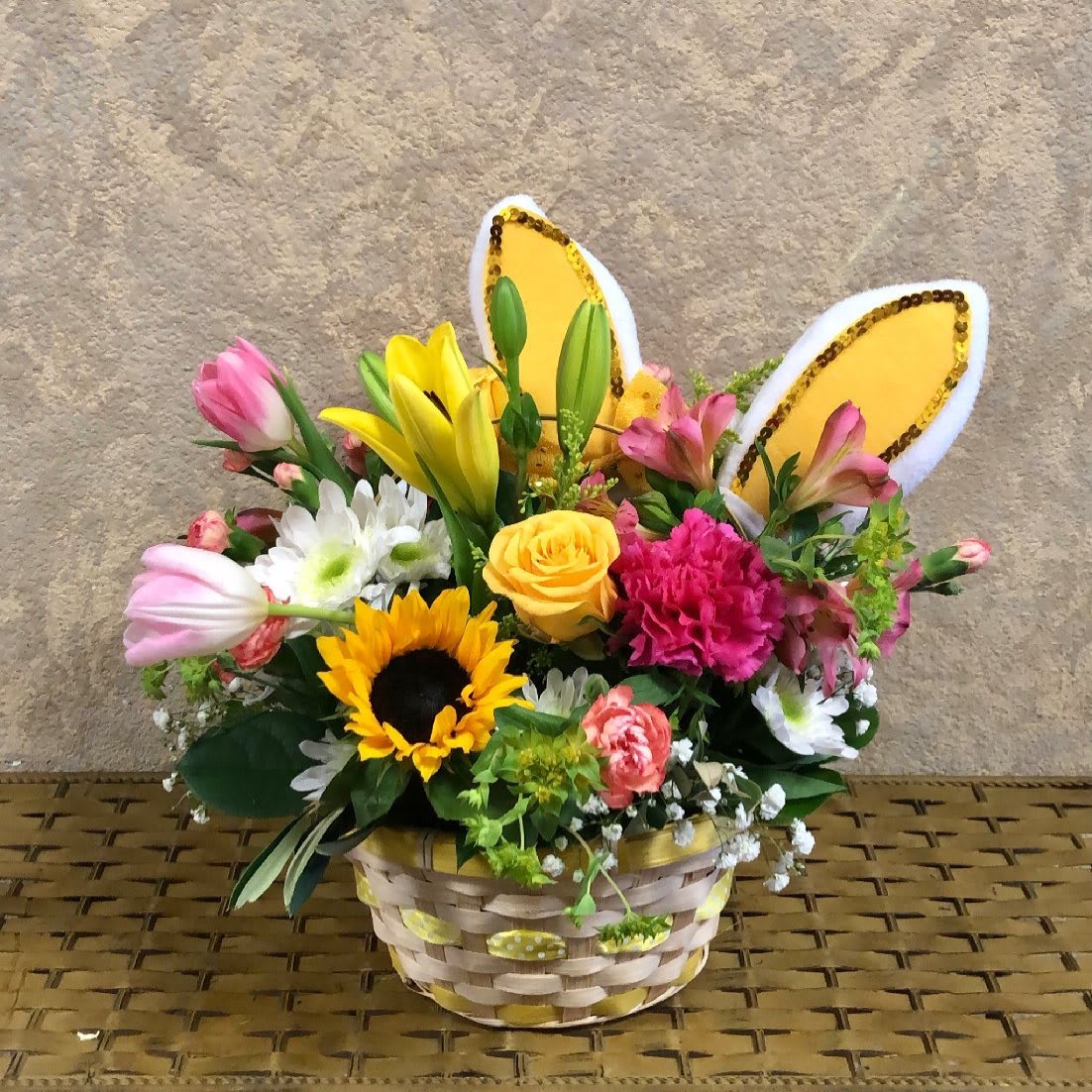 Bunny Wishes - Recipe: Roses, Sunflowers, Tulips, Daisies, Carnations, Mini Carnations, Alstroemeria, and more with bunny ears. Dimensions: Wicker Basket Substitute Available in different colors. Seasonal: All year round