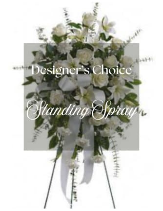 White standing spray with roses and lilies on an easel