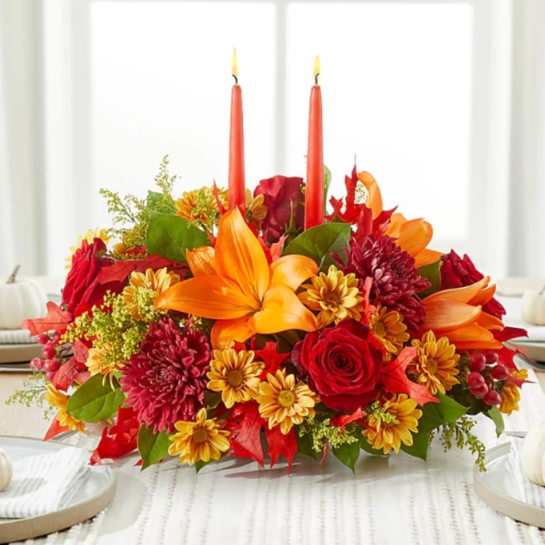 Autumn floral centerpiece with two red taper candles
