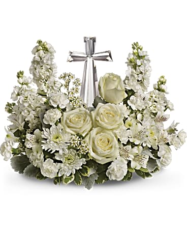 White floral arrangement with roses and a silver cross centerpiece