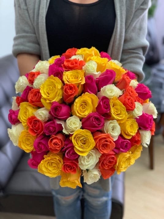 Large bouquet of multicolored roses in pink, yellow, orange, and white