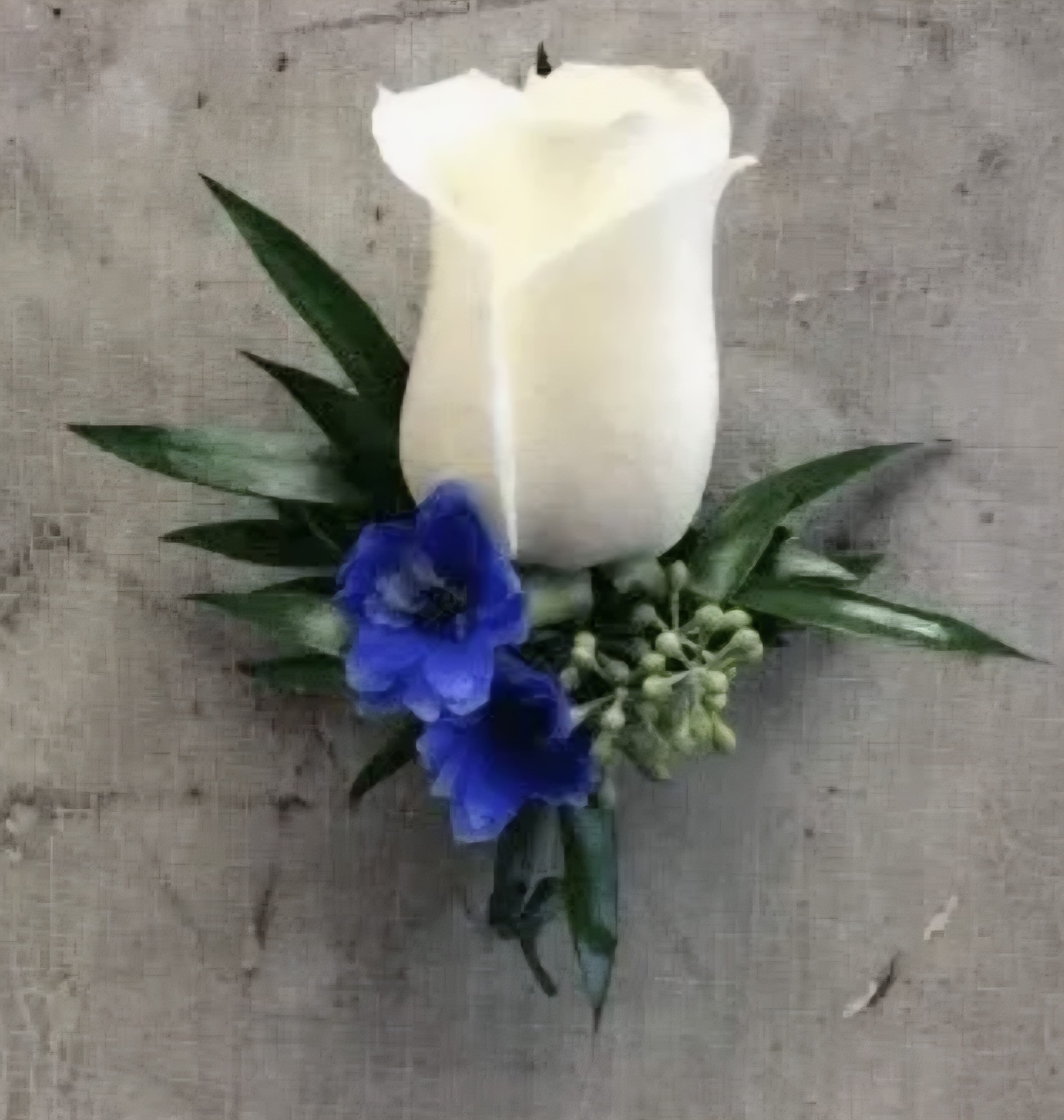 White calla lily boutonniere with blue flowers