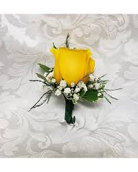 Yellow rose boutonniere with white filler flowers on a white background