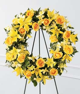 Yellow floral wreath on a black easel stand