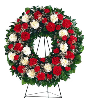 Red and white carnation wreath on a standing easel