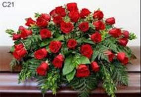 Large arrangement of red roses with green foliage