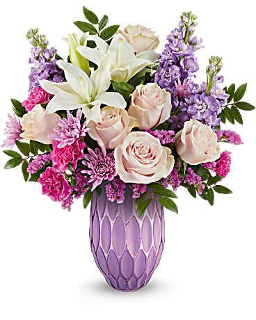 Pink roses and white lilies in a purple vase