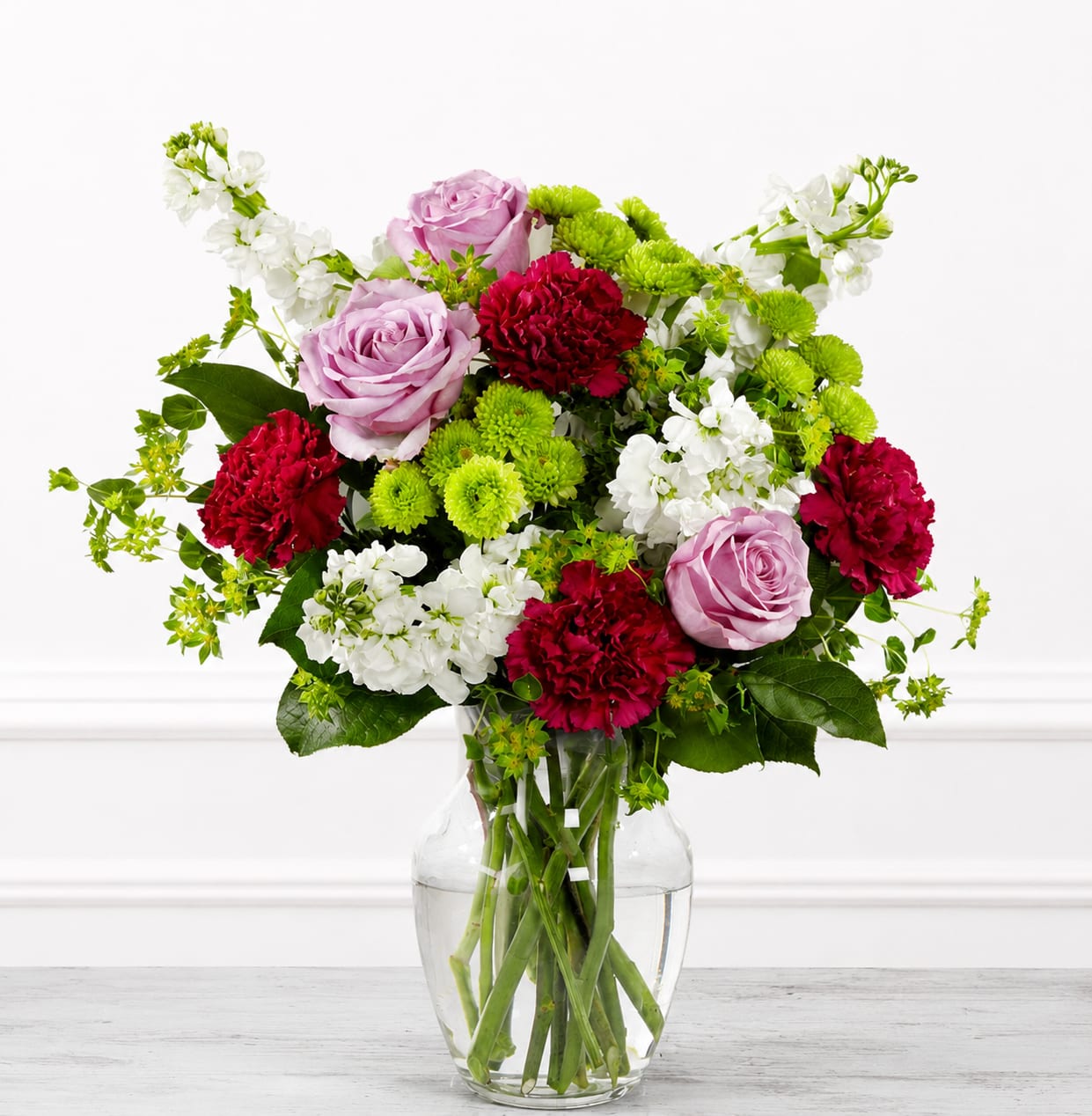 Lovely Bouquet - Choose this bouquet when you want the recipient to feel comforted, celebrated, or genuinely seen-the white hydrangeas soothe, the roses convey affection, and the carnations add warmth. Available in a clear glass vase with stems visible, it arrives ready to display; simple care-fresh water and a cool spot away from direct sun-will keep the arrangement looking fresh for days.