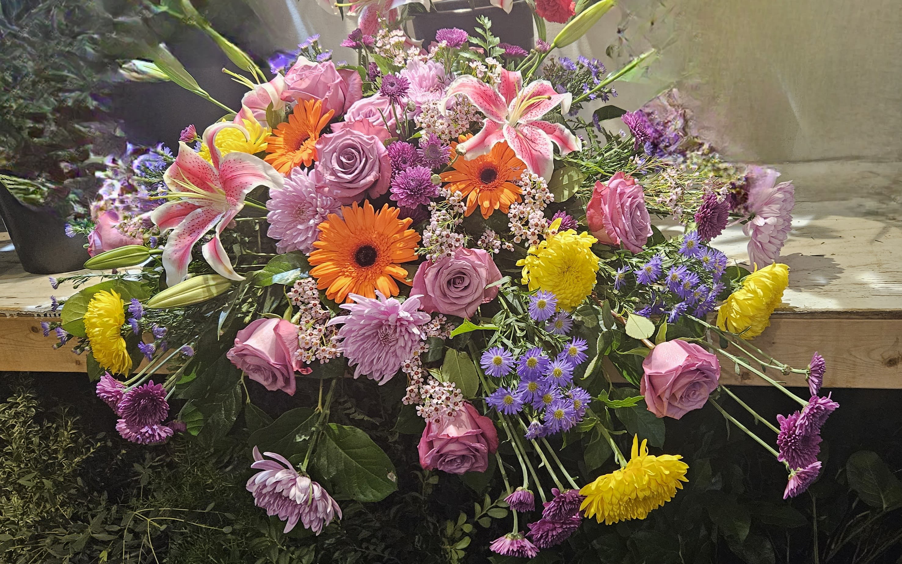 Mixed bouquet with pink roses, lilies, gerberas, and purple flowers
