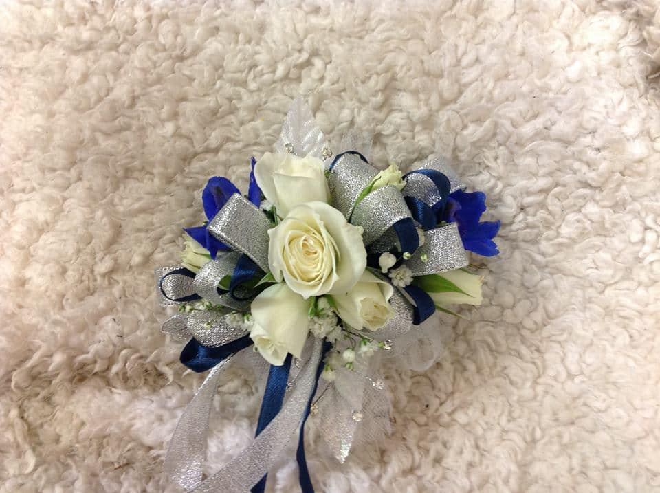 White rose corsage with blue and silver ribbon accents