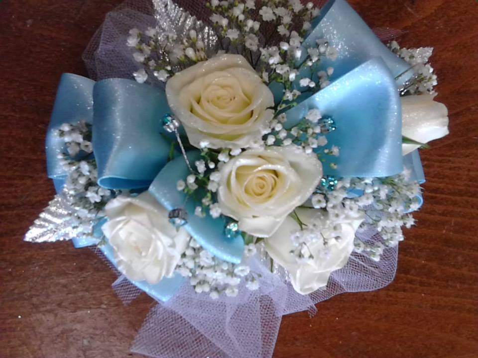 White roses with blue ribbon and baby's breath bouquet