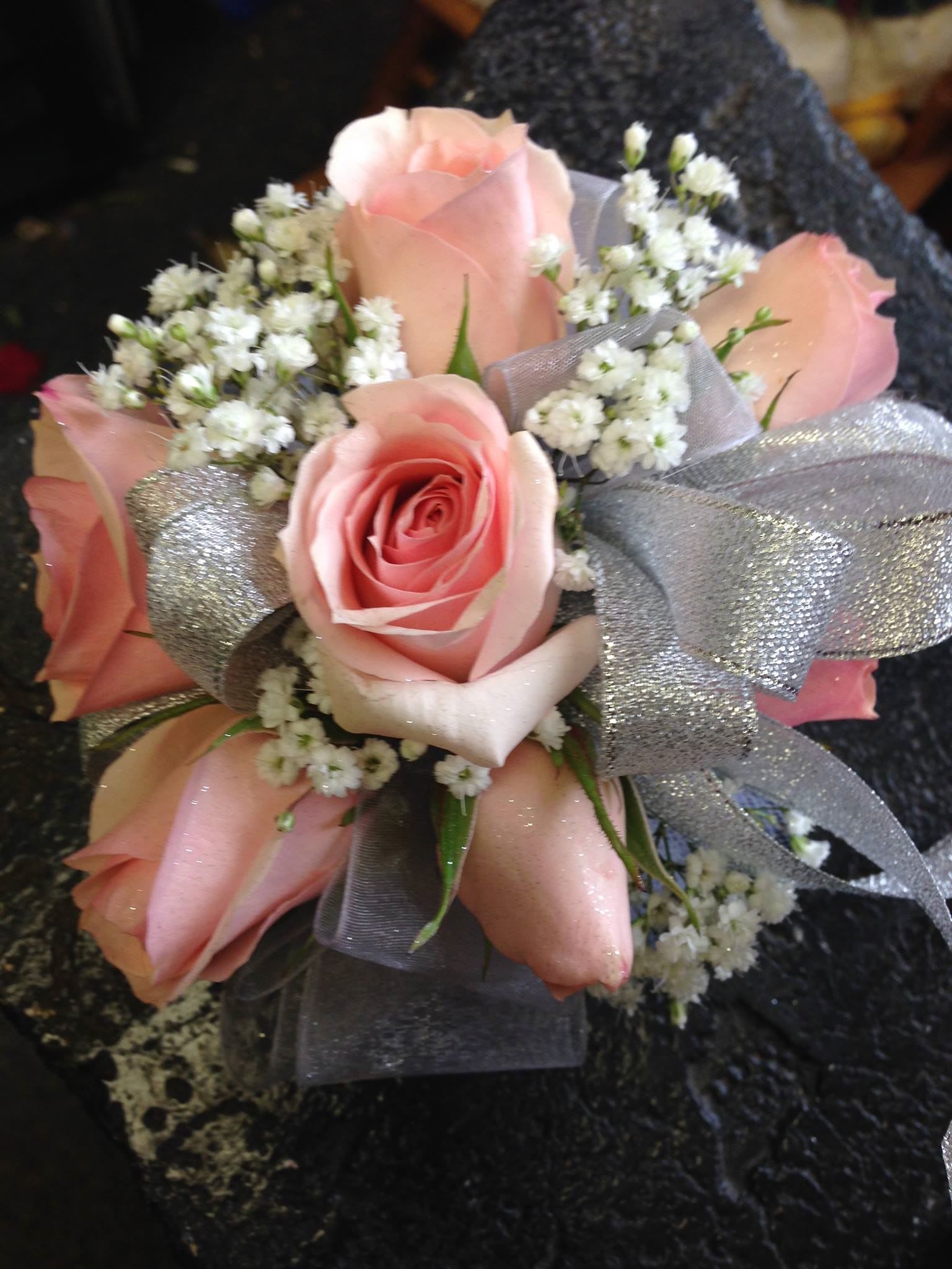 Pink rose bouquet with white filler flowers and silver ribbon