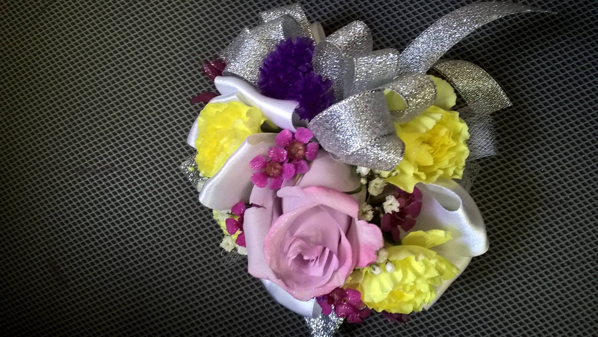 Small bouquet with pink and yellow flowers and silver ribbon