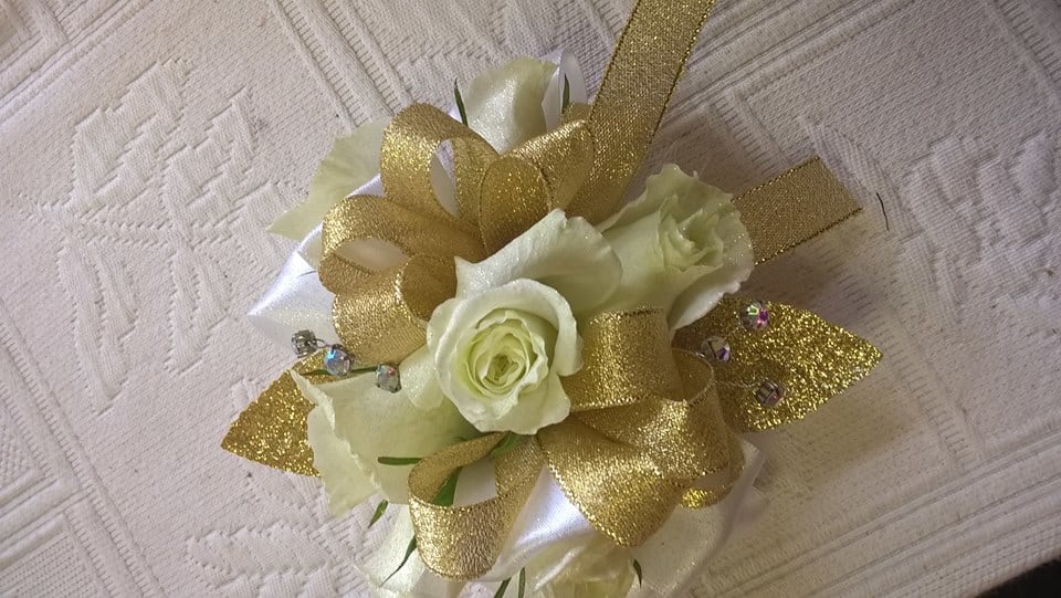 White rose corsage with gold ribbon and glitter accents
