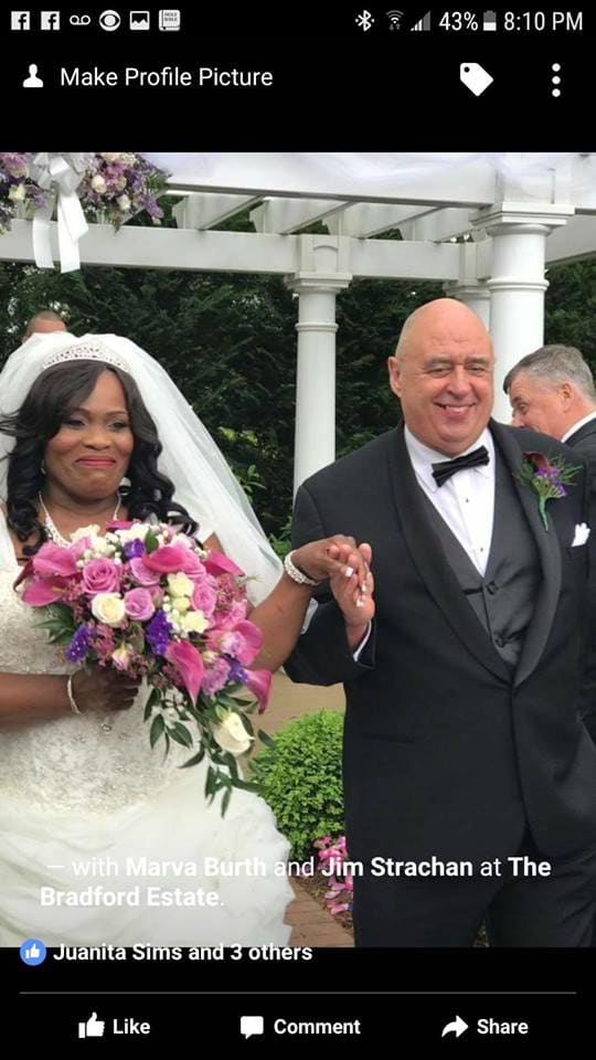Bride holding a pink and white bouquet beside a groom in a tuxedo