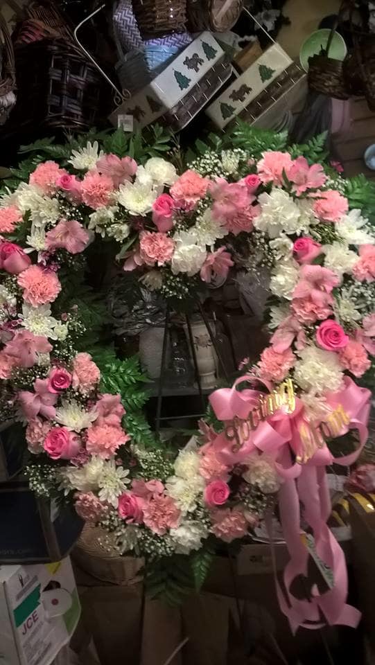 Pink and white floral wreaths with ribbon bows
