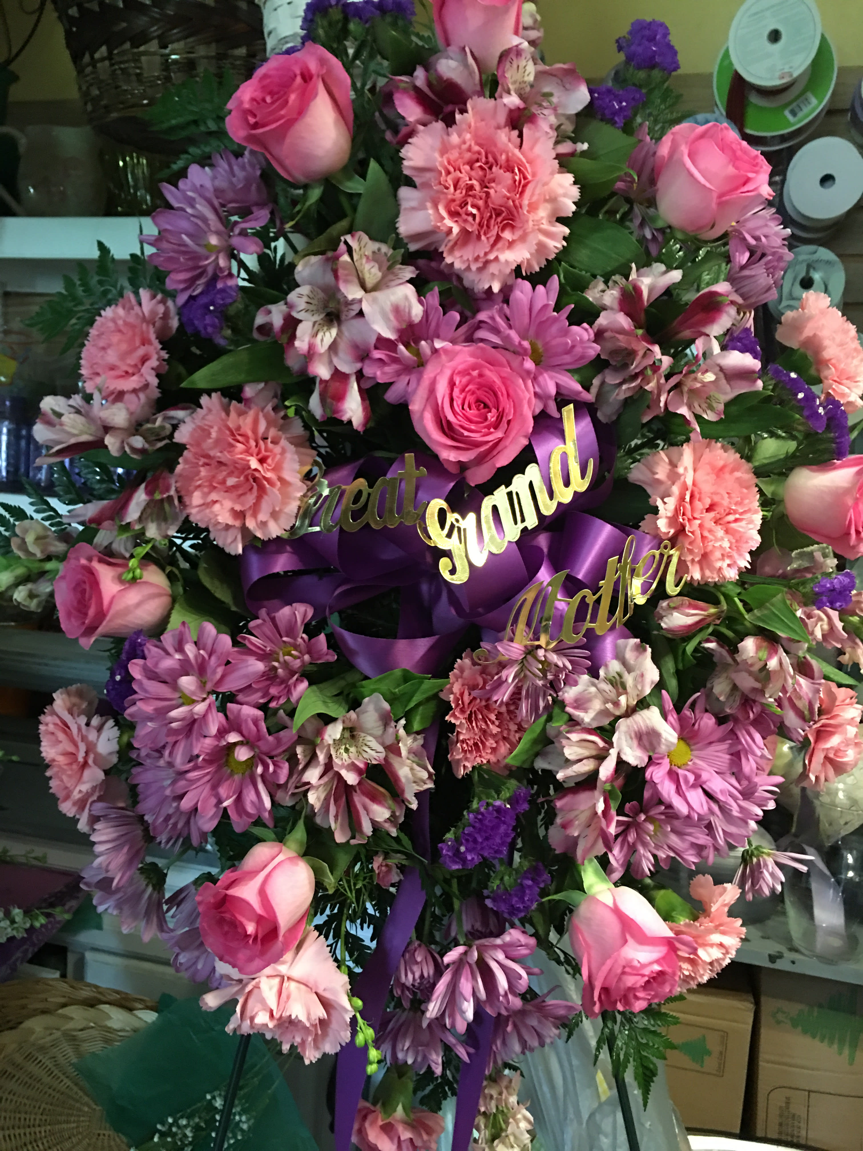Pink and purple floral wreath with roses and ribbon