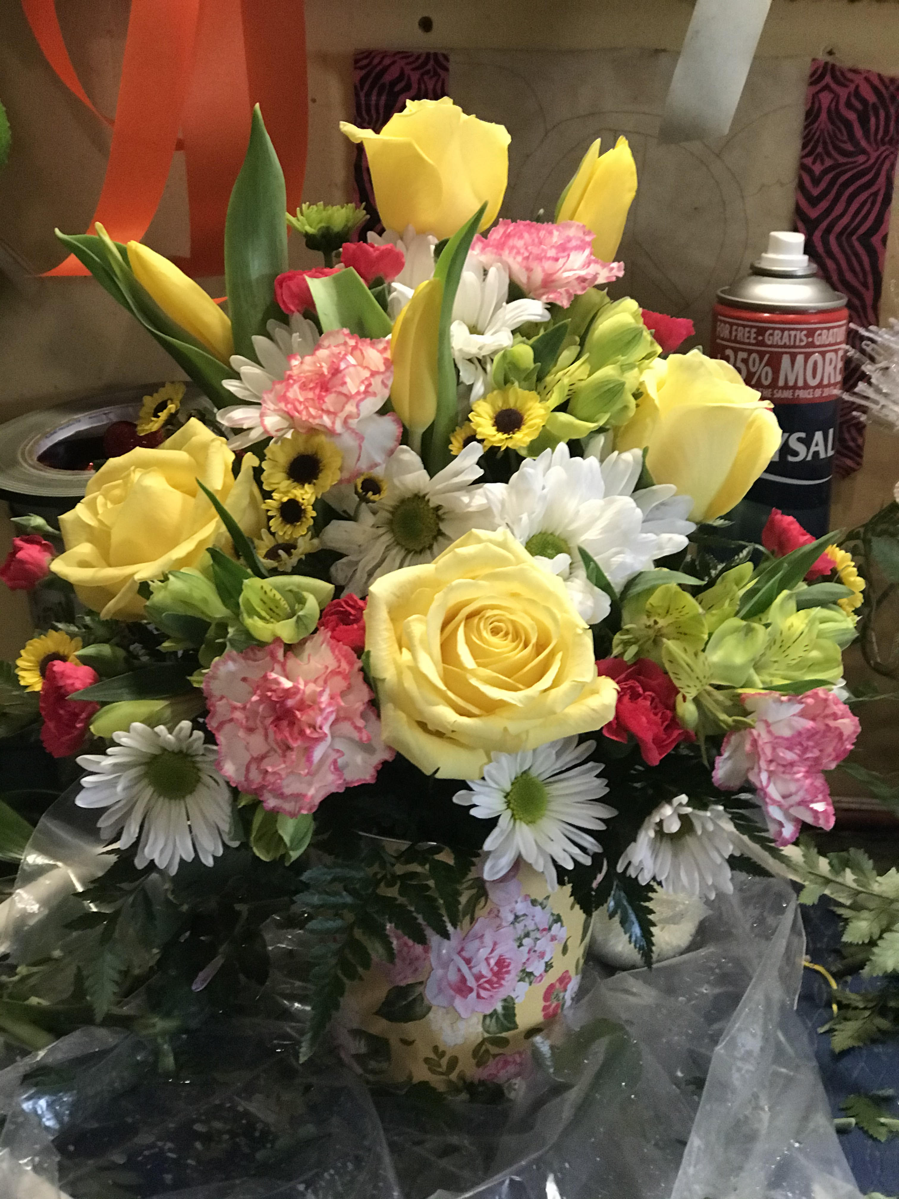 Mixed bouquet of yellow roses, daisies, carnations, and tulips