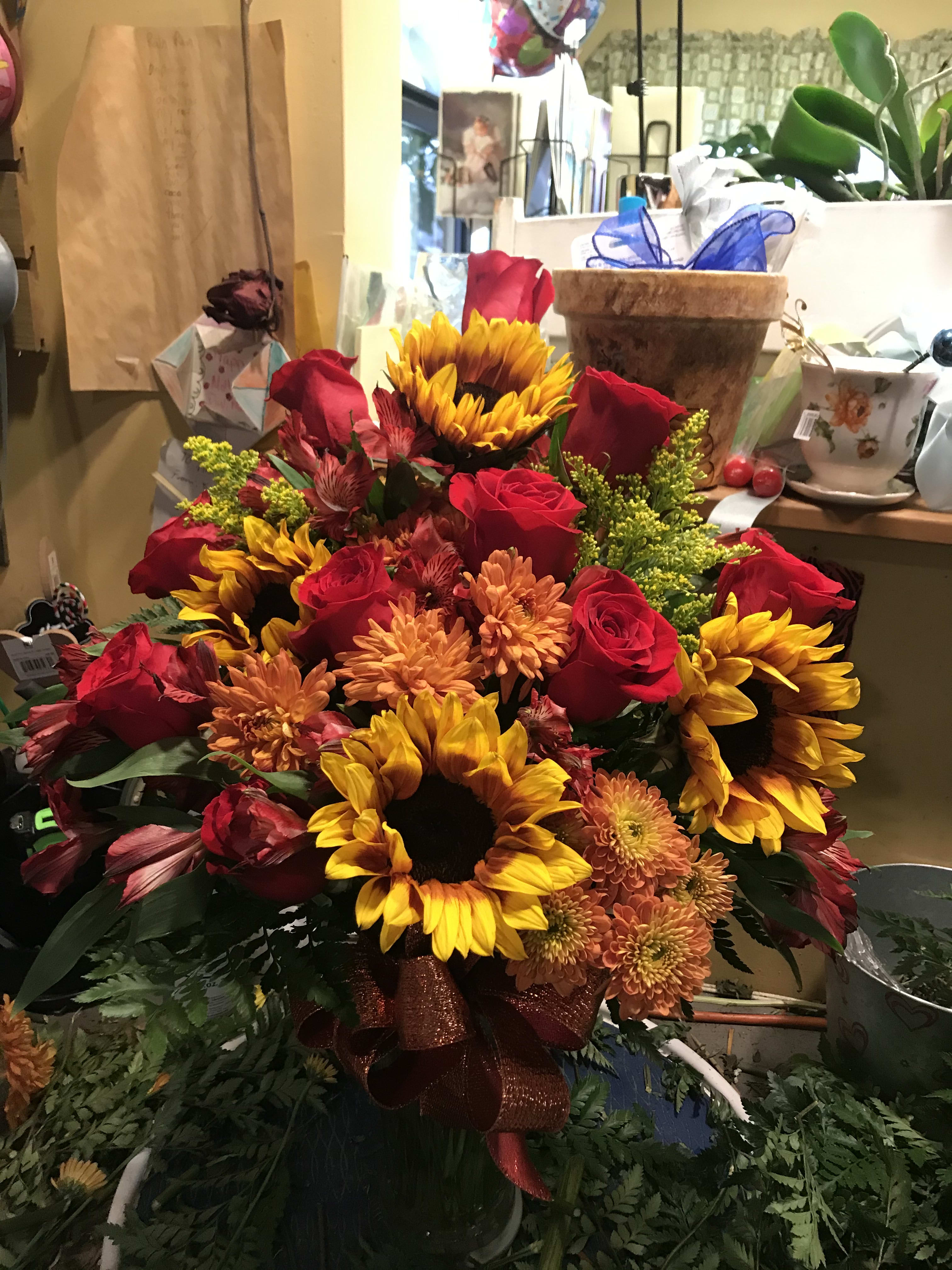 Bouquet of red roses and sunflowers with orange mums