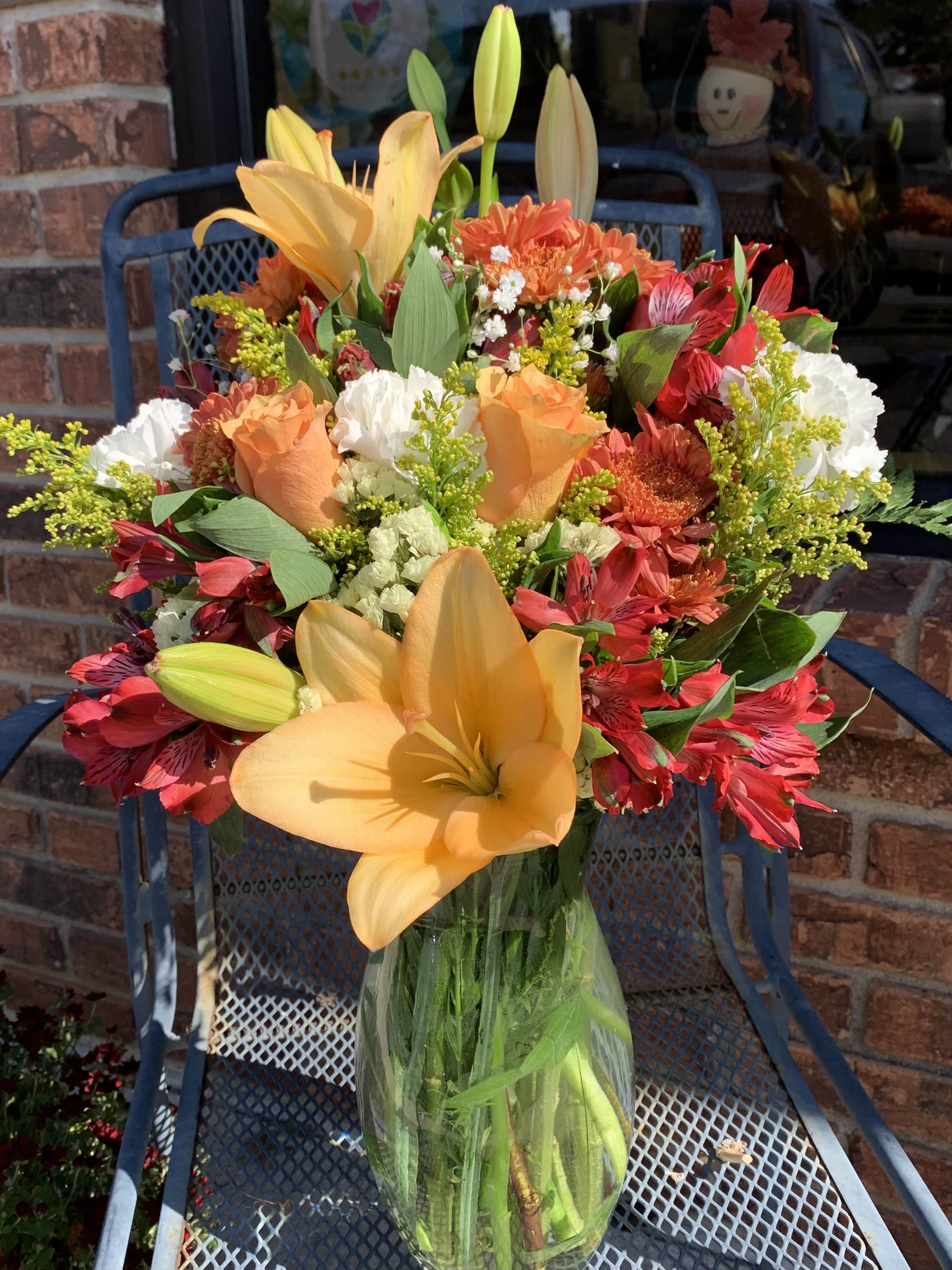 Fall Sunrise - Capture the magic of a fall sunrise with this mix of radiant orange roses and lilies! Colors may vary upon availability -One sided arrangement as shown - please specify in special instructions if you would prefer a centerpiece