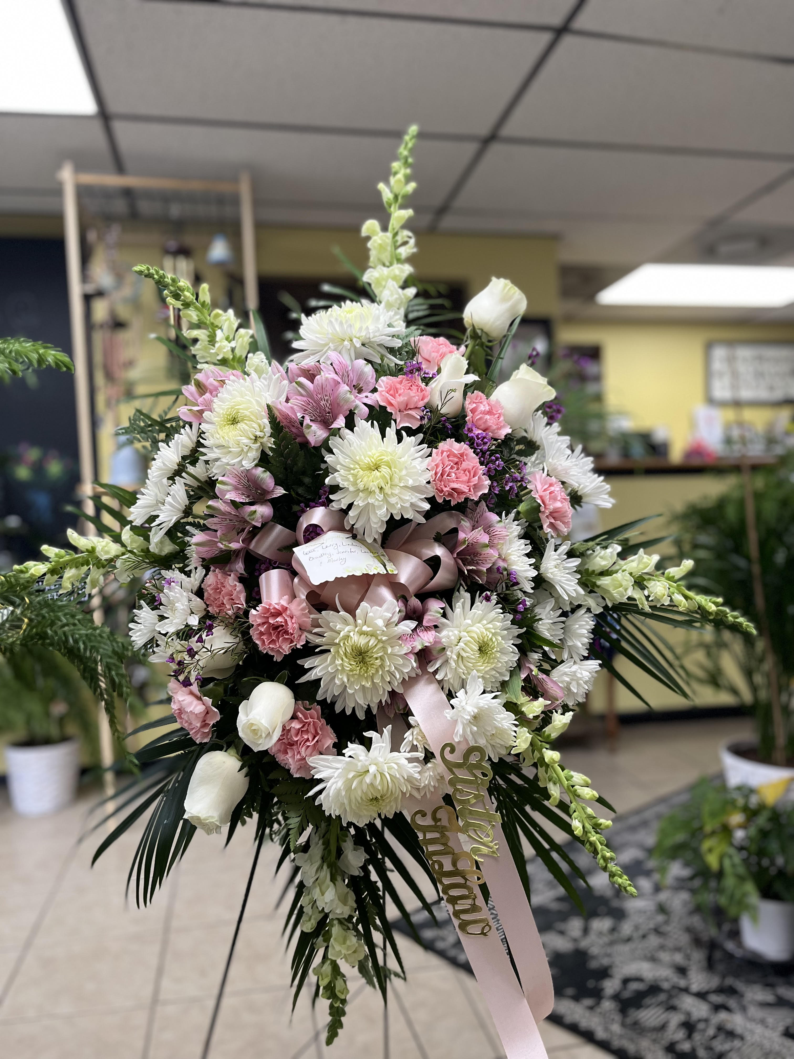Large pink and white floral spray with ribbon and card