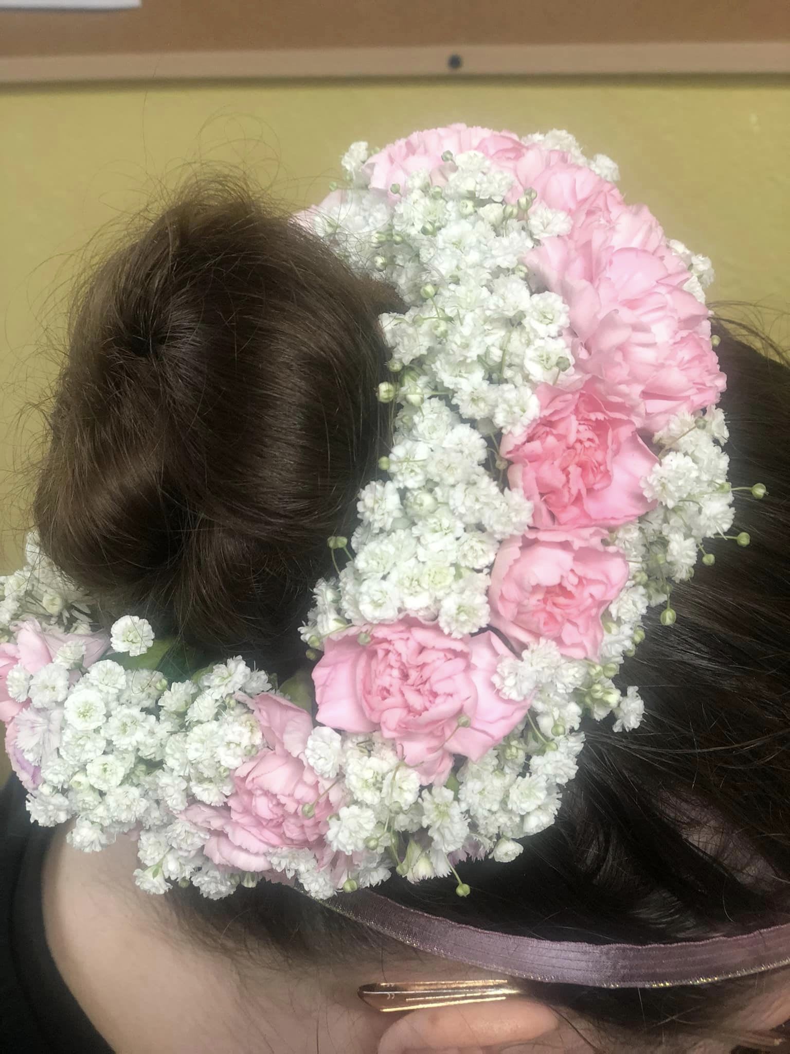 Pink flower crown on a person's head