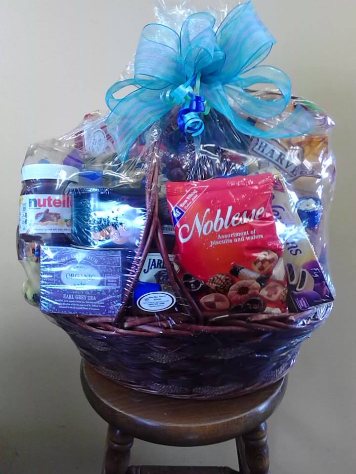 Gift basket with assorted snacks and a blue ribbon bow