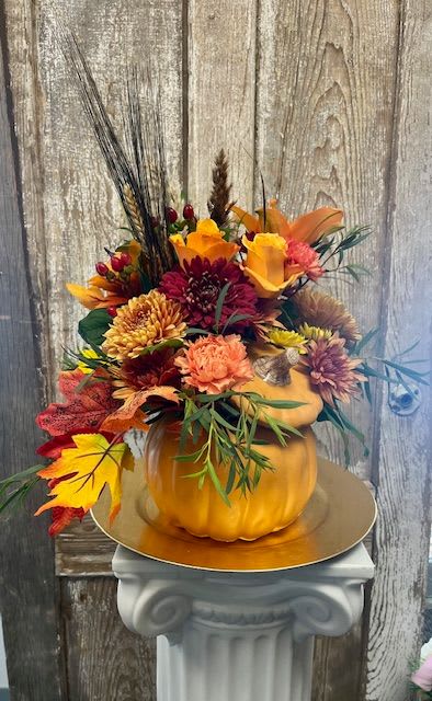 PUMPKIN PATCH - A handpicked selection of a variety of beautiful, fall toned flowers designed in an orange ceramic pumpkin that can be refilled year after year with fresh flowers or as fall home décor for years to come.