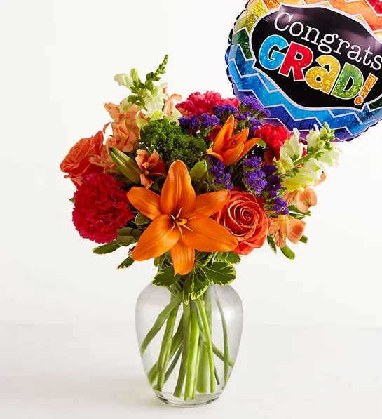Vibrant Floral Medley for Graduation -  Congratulate the superstar grad with a beautiful gift. Our delightfully vibrant bouquet is filled with a medley of blooms in cheerful pops of orange, hot pink and yellow and bundled with a festive balloon. 