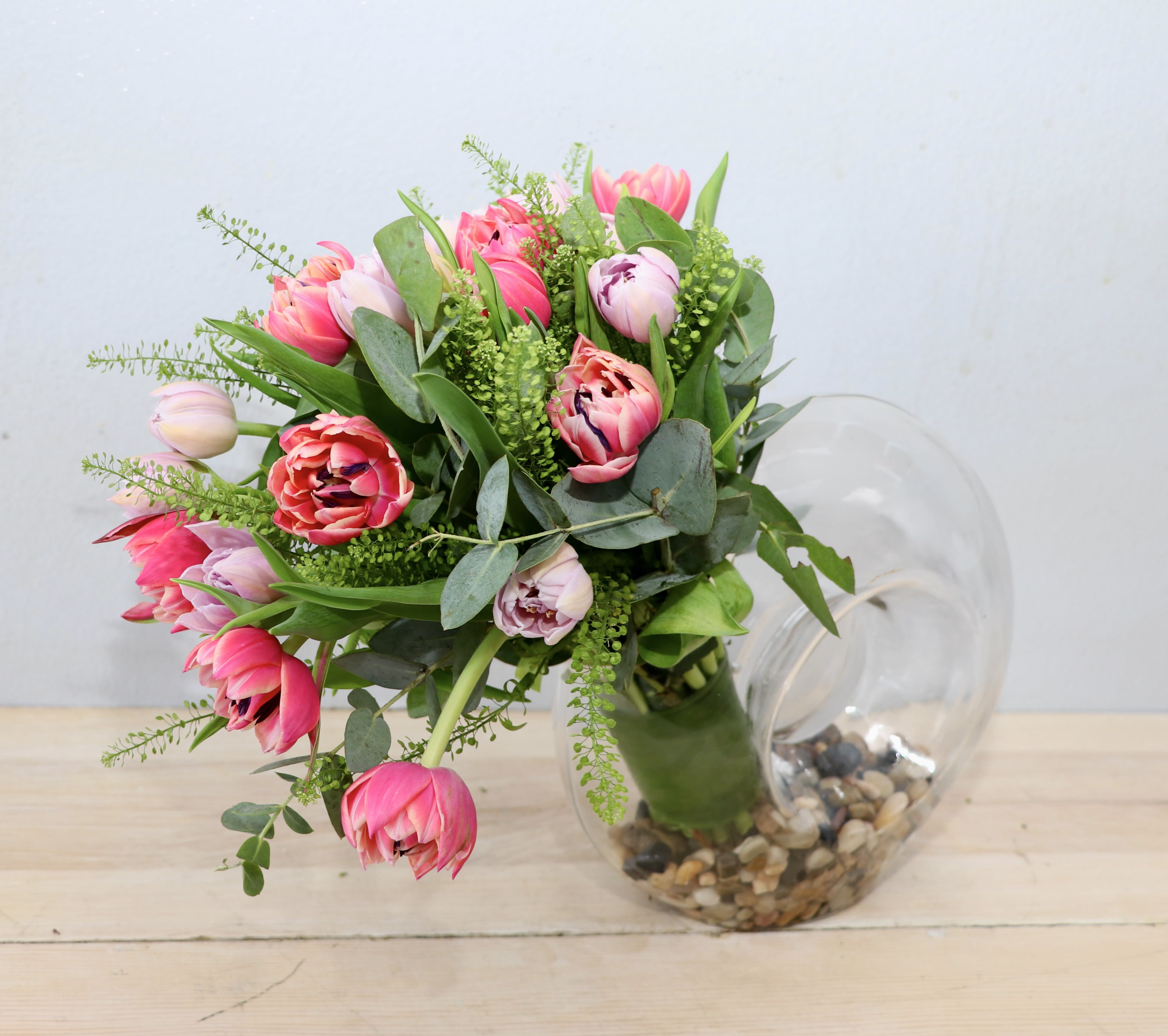 Contemporary Tulips - A beautiful arrangement of 20 tulips in a modern glass vase lined with pebbles. 