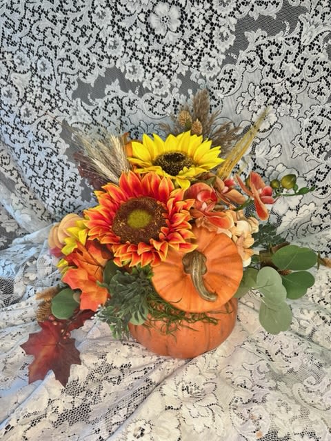 Silk Floral Ceramic Pumpkin - Silk flowers in Fall tones adorn this orange ceramic pumpkin. The recipient will enjoy this arrangement for years to come!