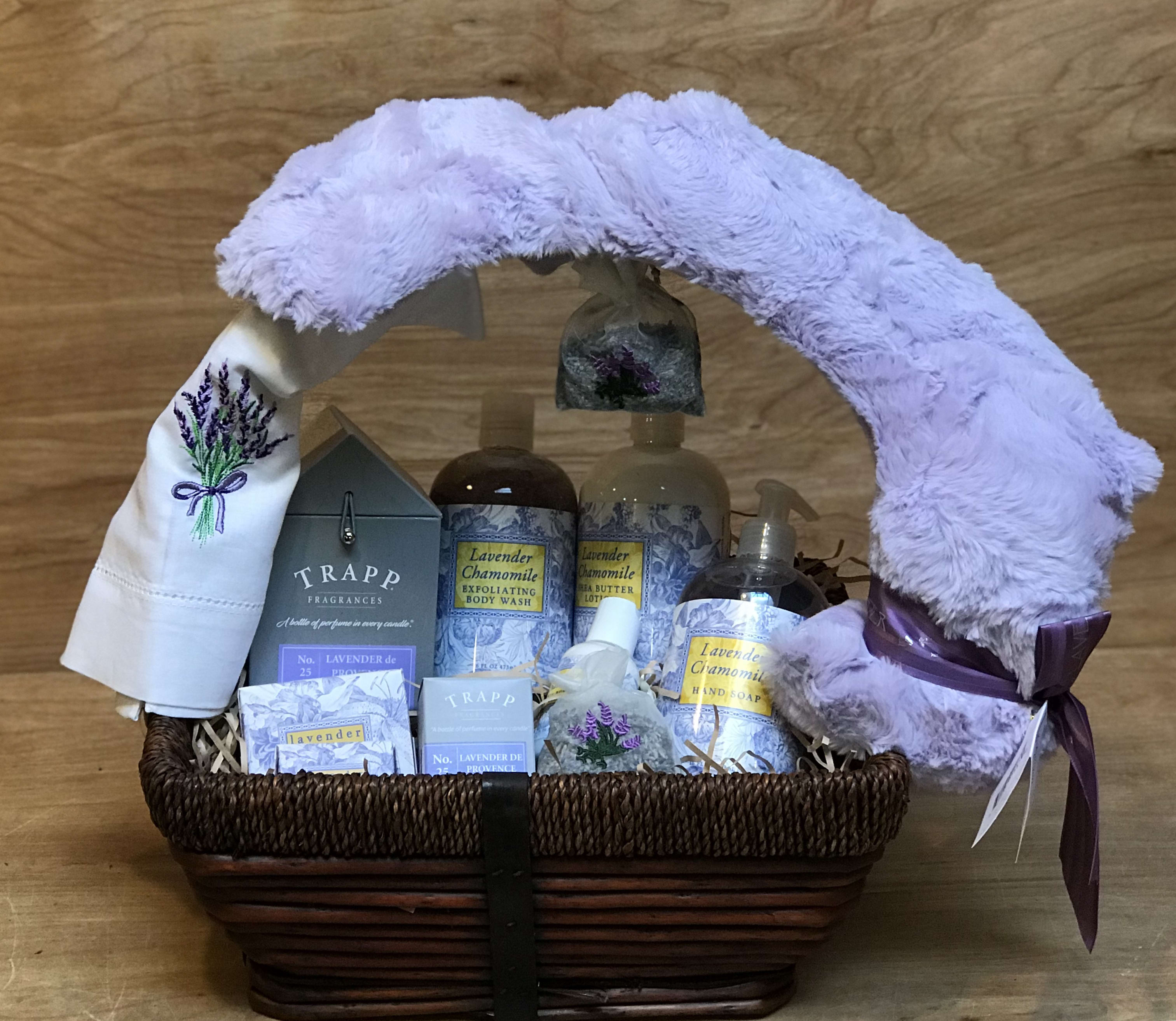 Lavender-themed gift basket with plush blanket and bath products