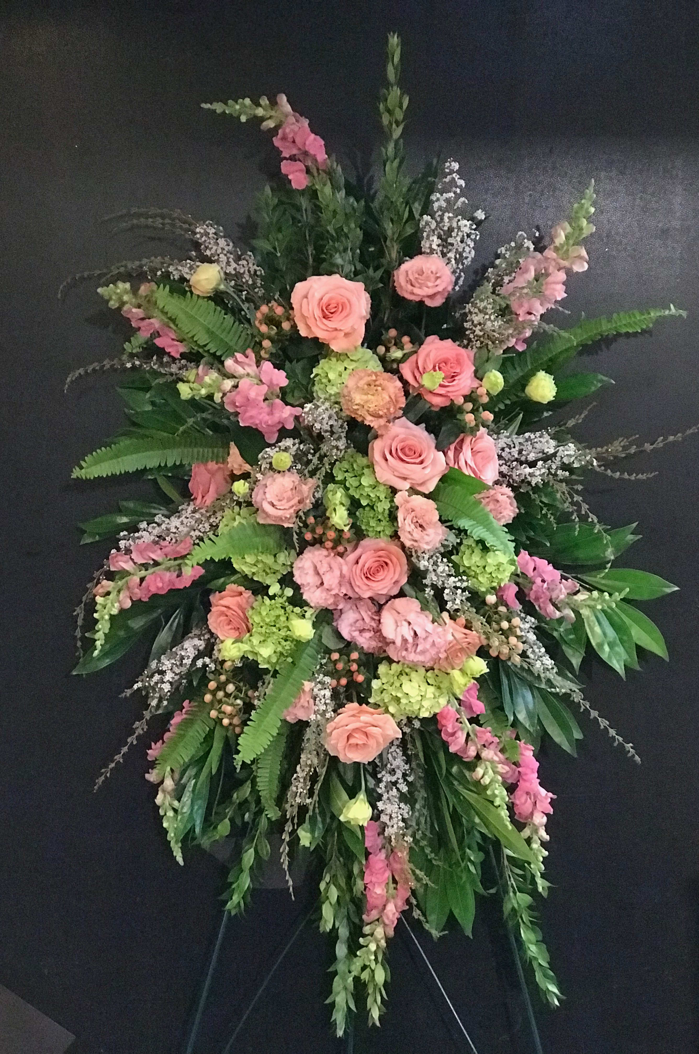 Large pink and green funeral spray with roses and lilies