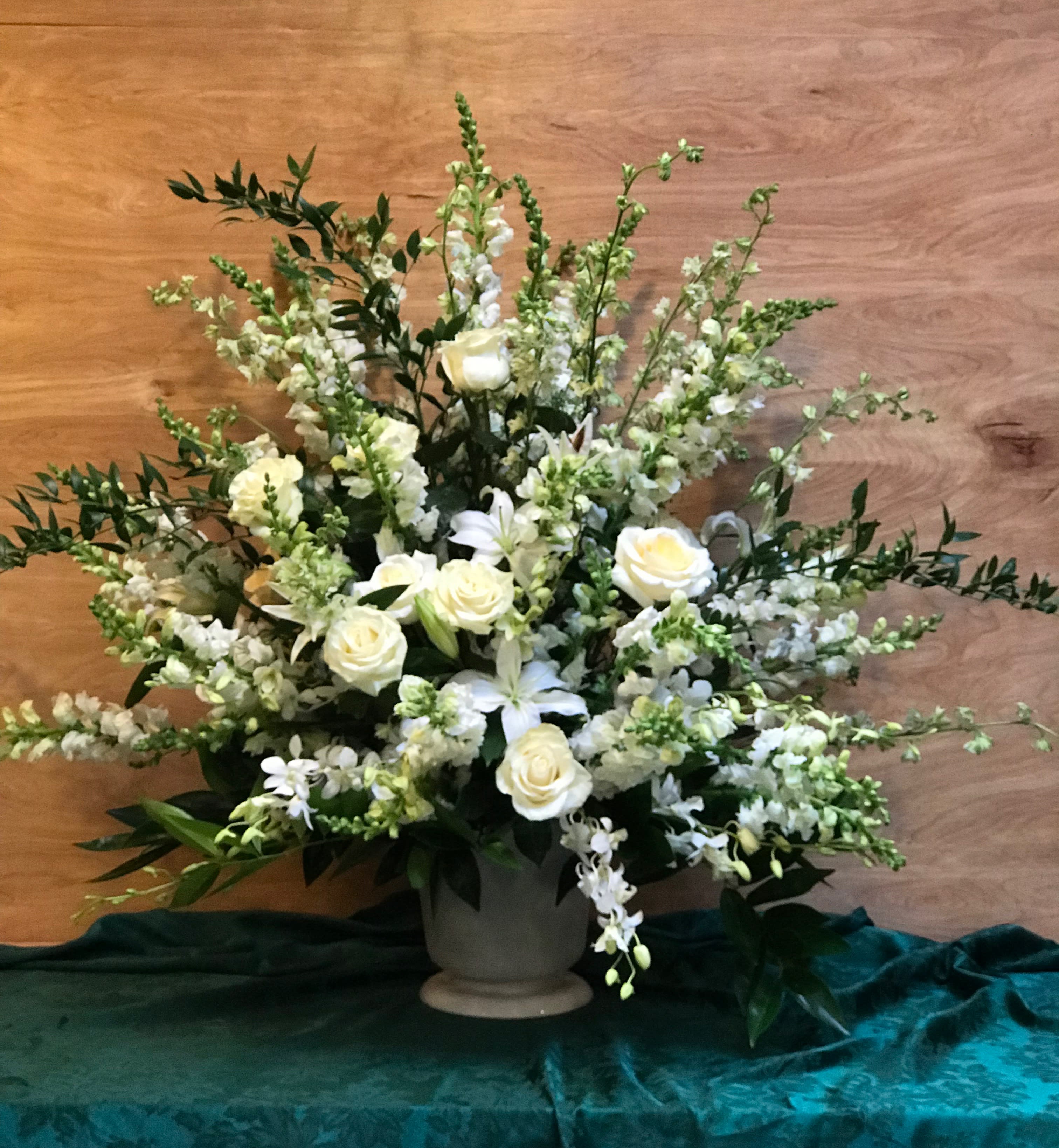 White roses and lilies arranged in a gray vase