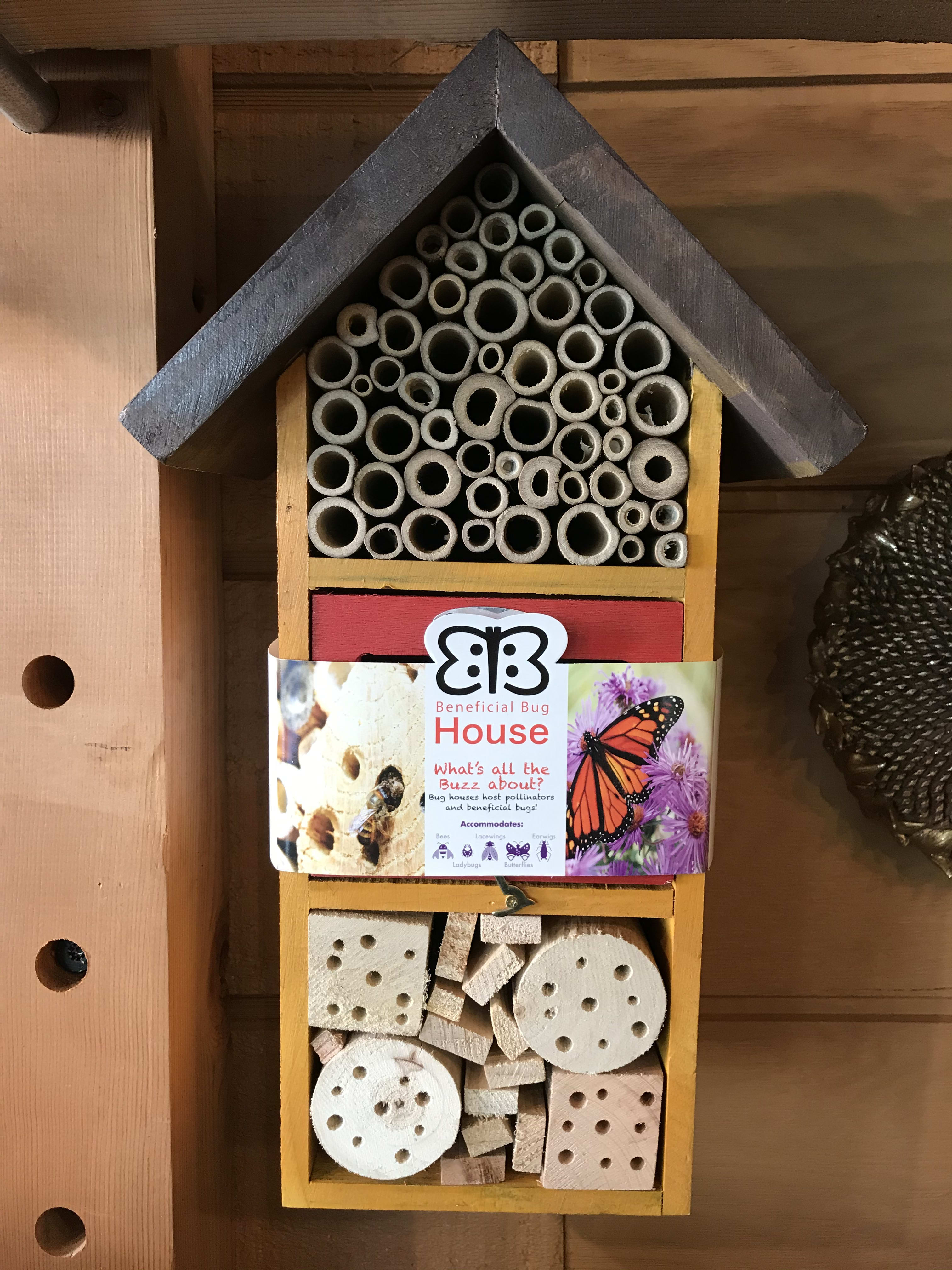 Wooden insect house with bamboo tubes and drilled wood blocks
