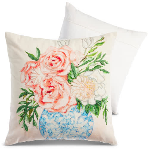 Decorative pillow with painted pink and white flowers in a blue vase