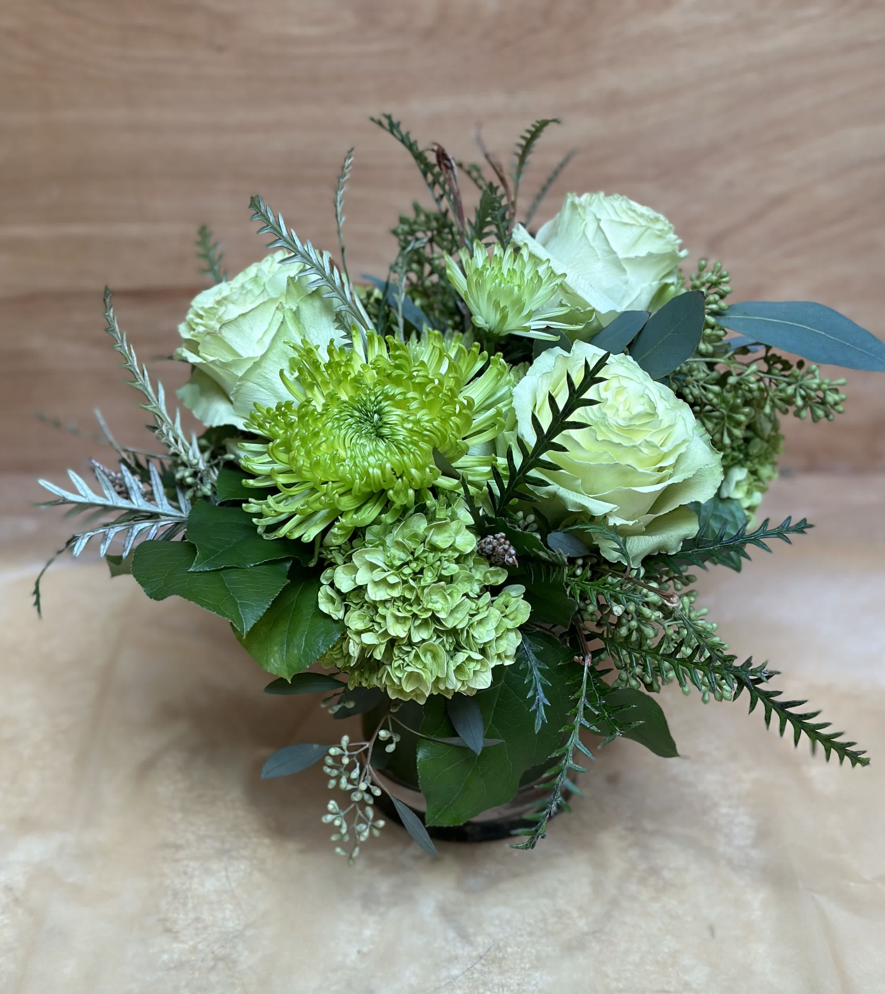 Green and white bouquet with roses and chrysanthemums in a vase