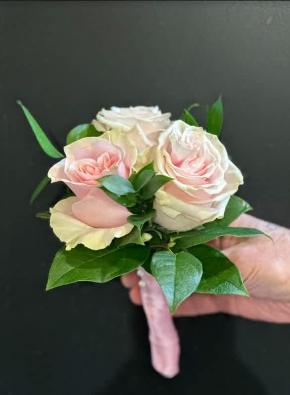 Small bouquet of pale pink roses with green leaves