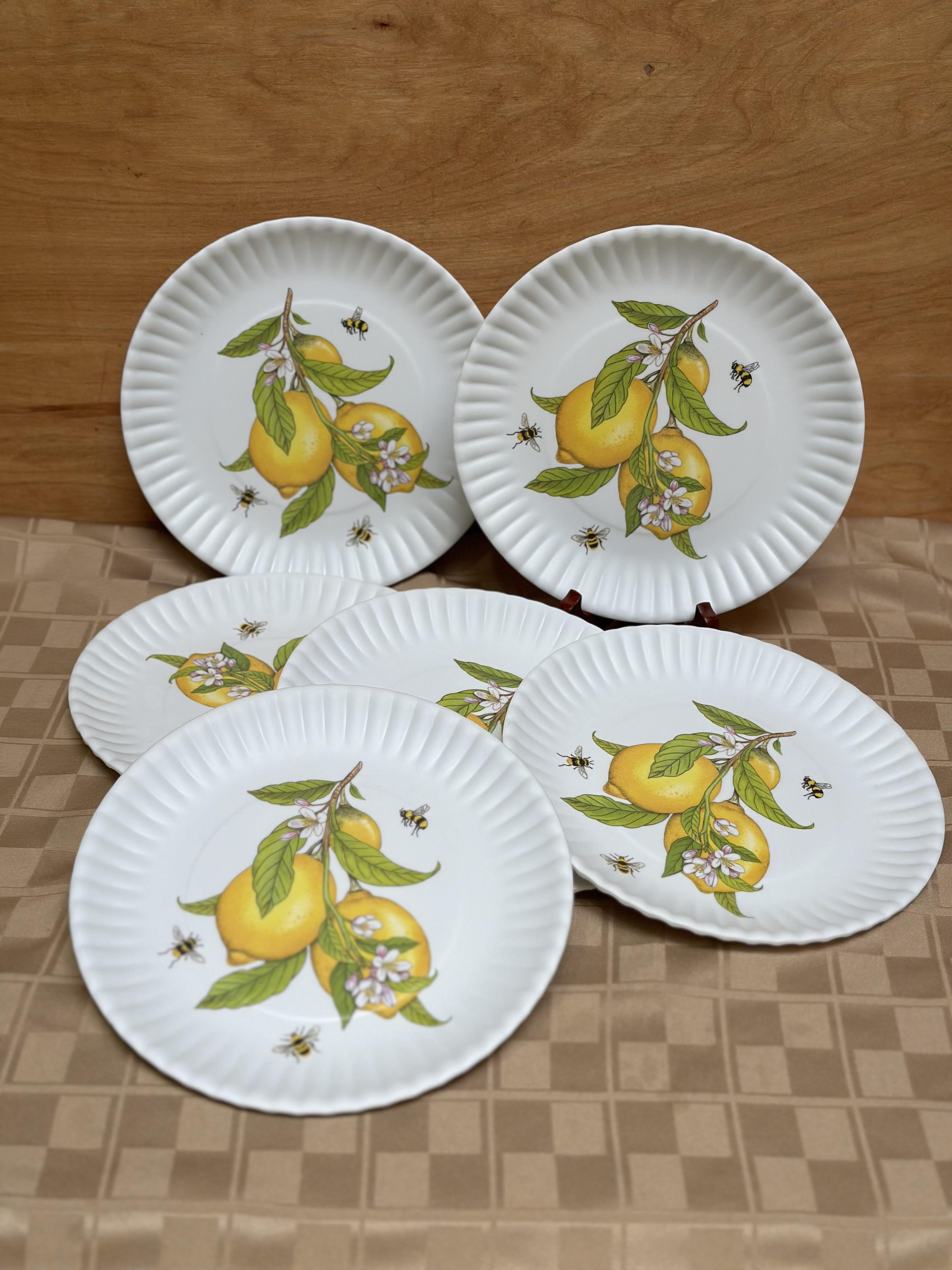 Set of white paper plates with lemon and bee designs