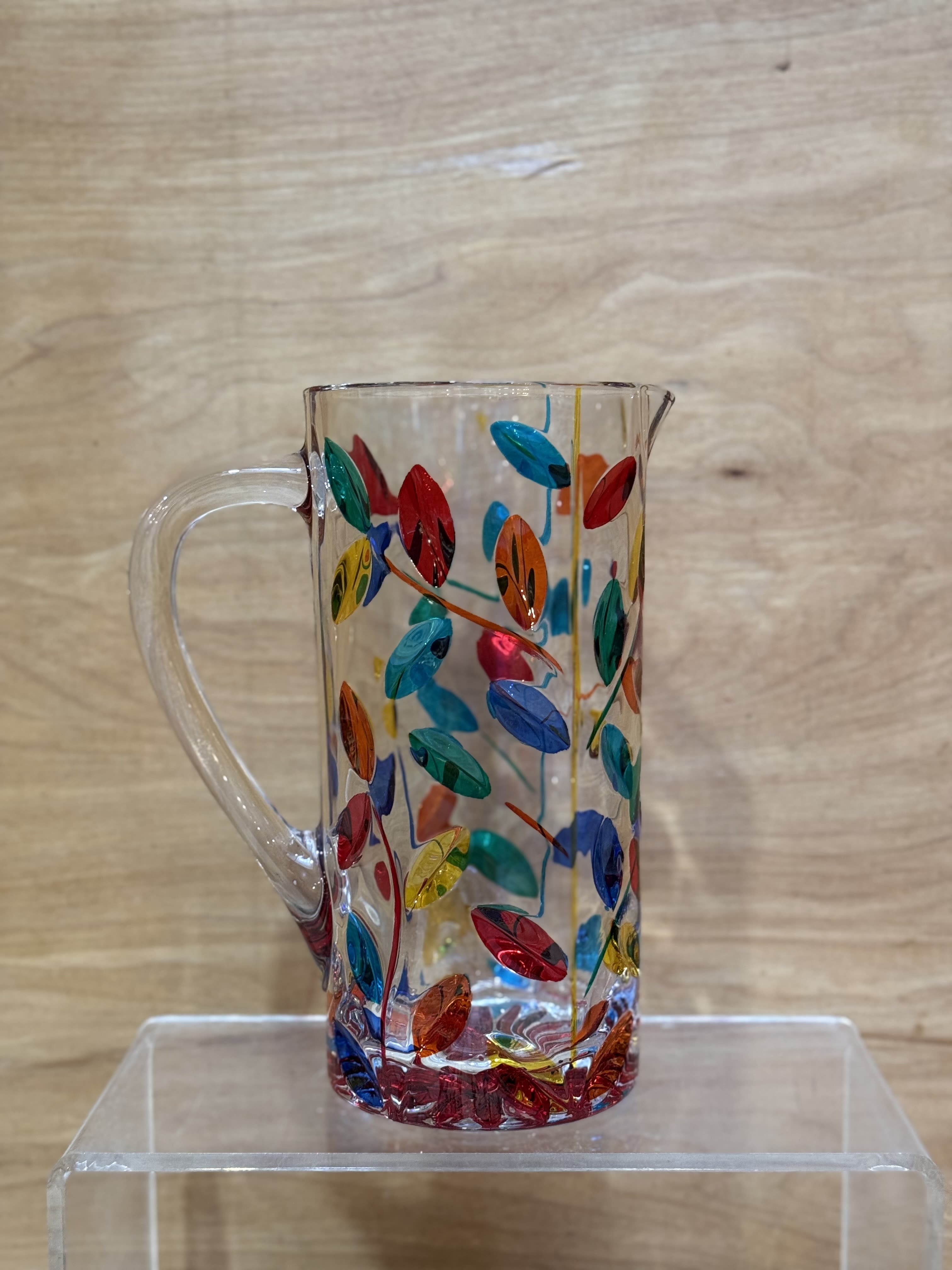 Clear glass pitcher with colorful leaf pattern