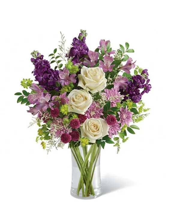 Lush Lavender Bouquet - Creamy white roses set against a wash of lavender, purple and pink make this flower arrangement an effortless way to say "thinking of you," "thank you," or "happy birthday." The Lush Lavender Bouquet is a rounded, garden-style bouquet designed for everyday gifting and celebrations-the soft white roses bring calm and grace while the richer violet tones add warmth and cheer the recipient will notice.  