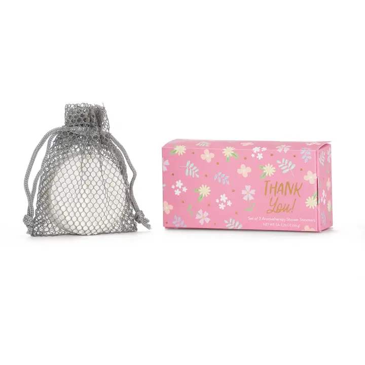Pink floral gift box beside a mesh drawstring pouch with a white item inside