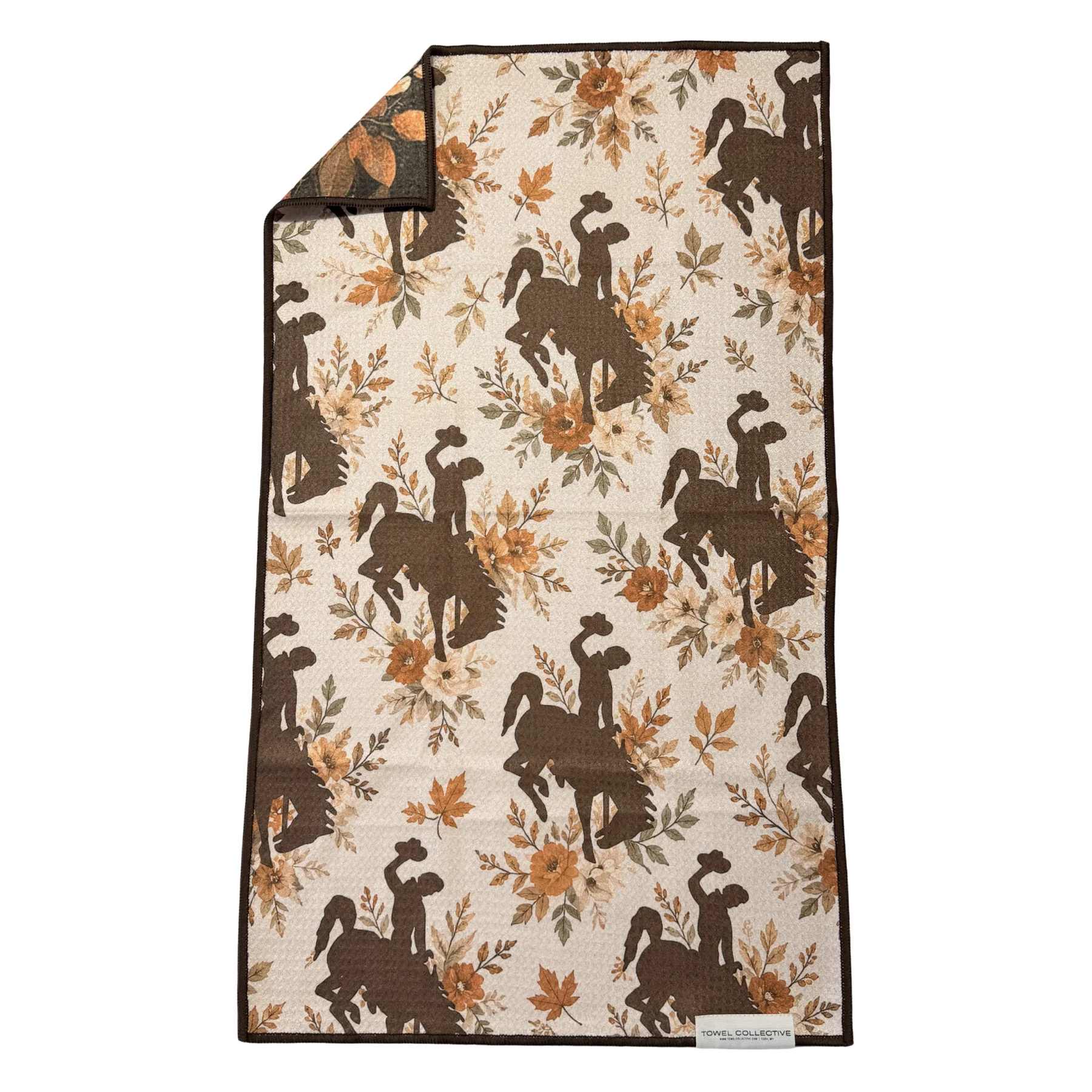 Patterned quilted throw with cowboy silhouettes and autumn flowers