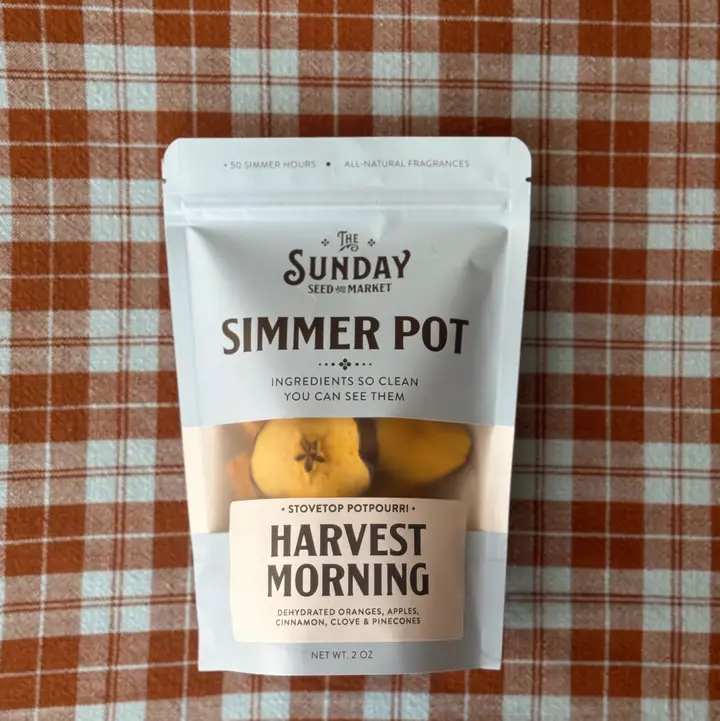 Package of harvest simmer pot potpourri on a plaid cloth