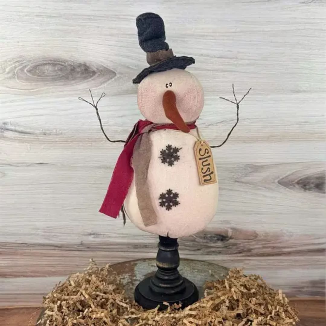 Decorative snowman figurine with a scarf and hat on a stand