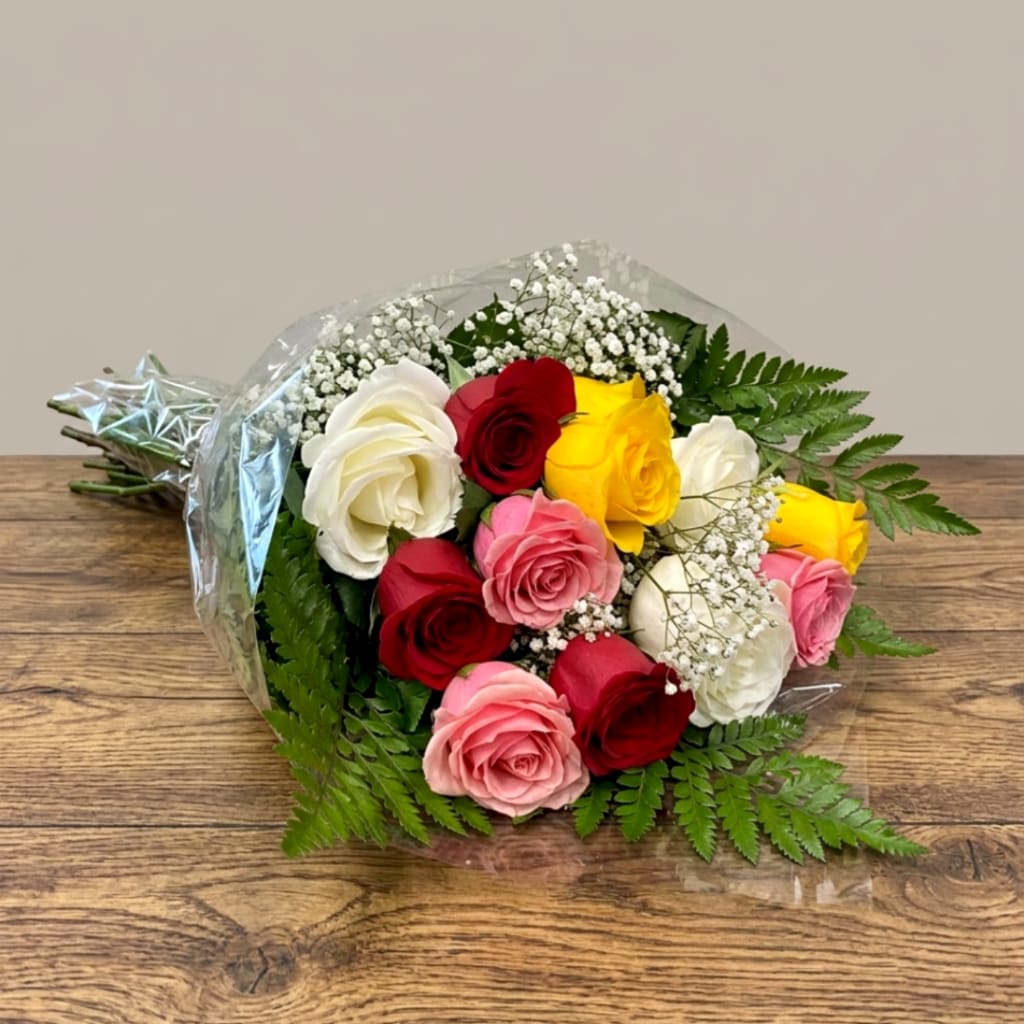 Bouquet of multicolored roses with baby's breath and fern foliage