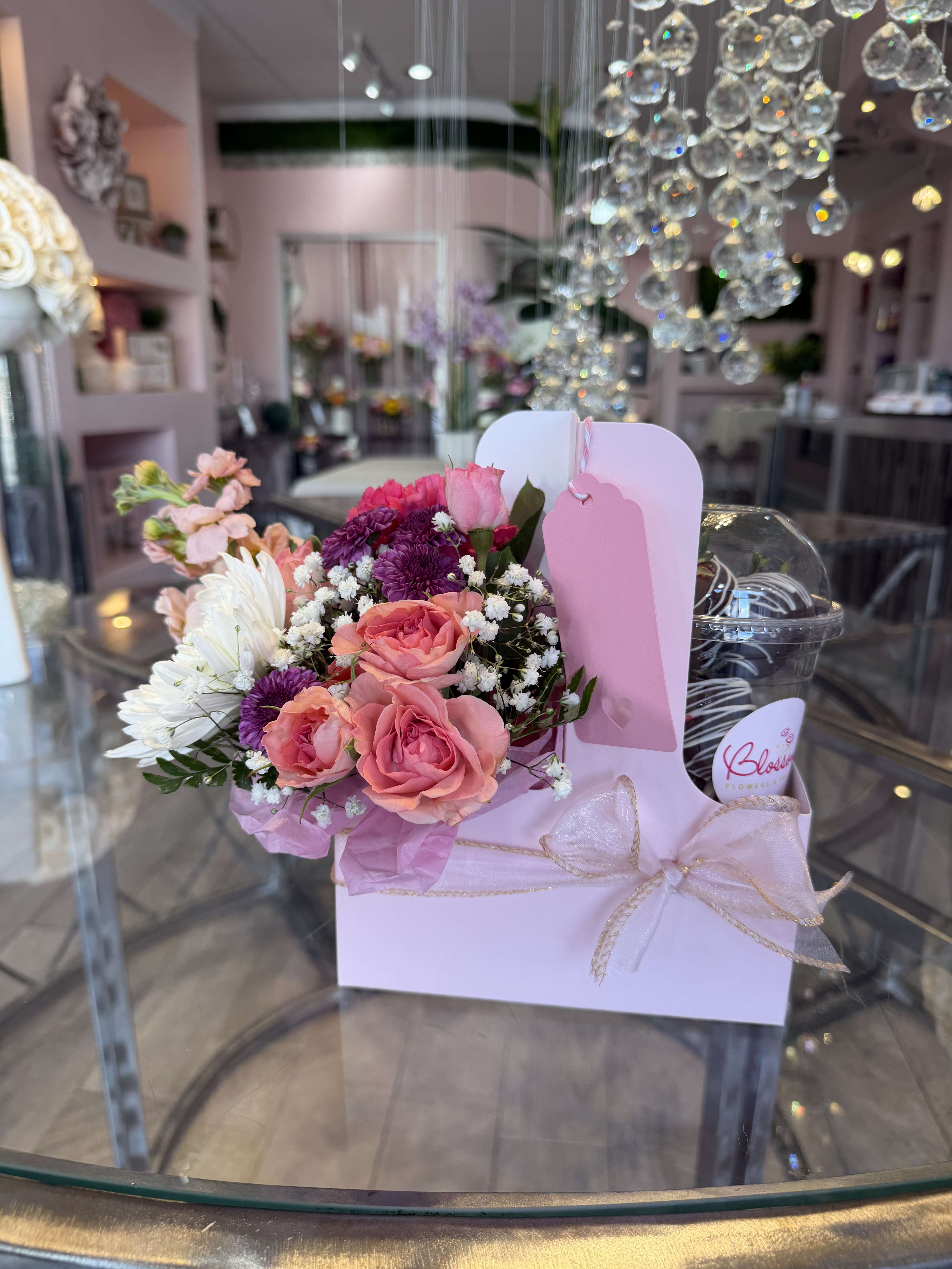 Pink and white bouquet in a pastel gift box with a ribbon